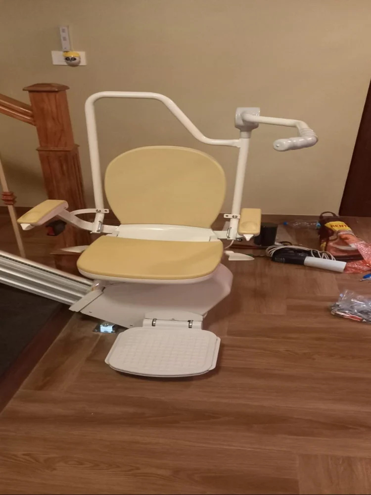 Standing perch stair lift installed on a narrow staircase